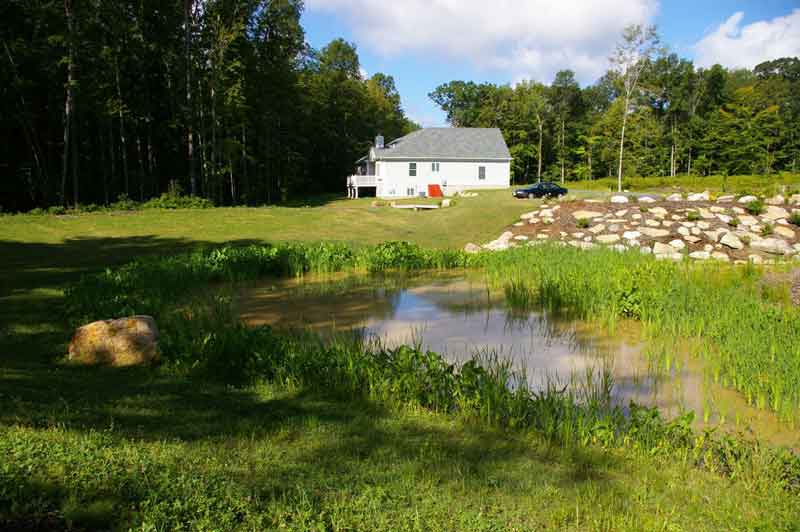 Pond with view of the Tracey Model Home